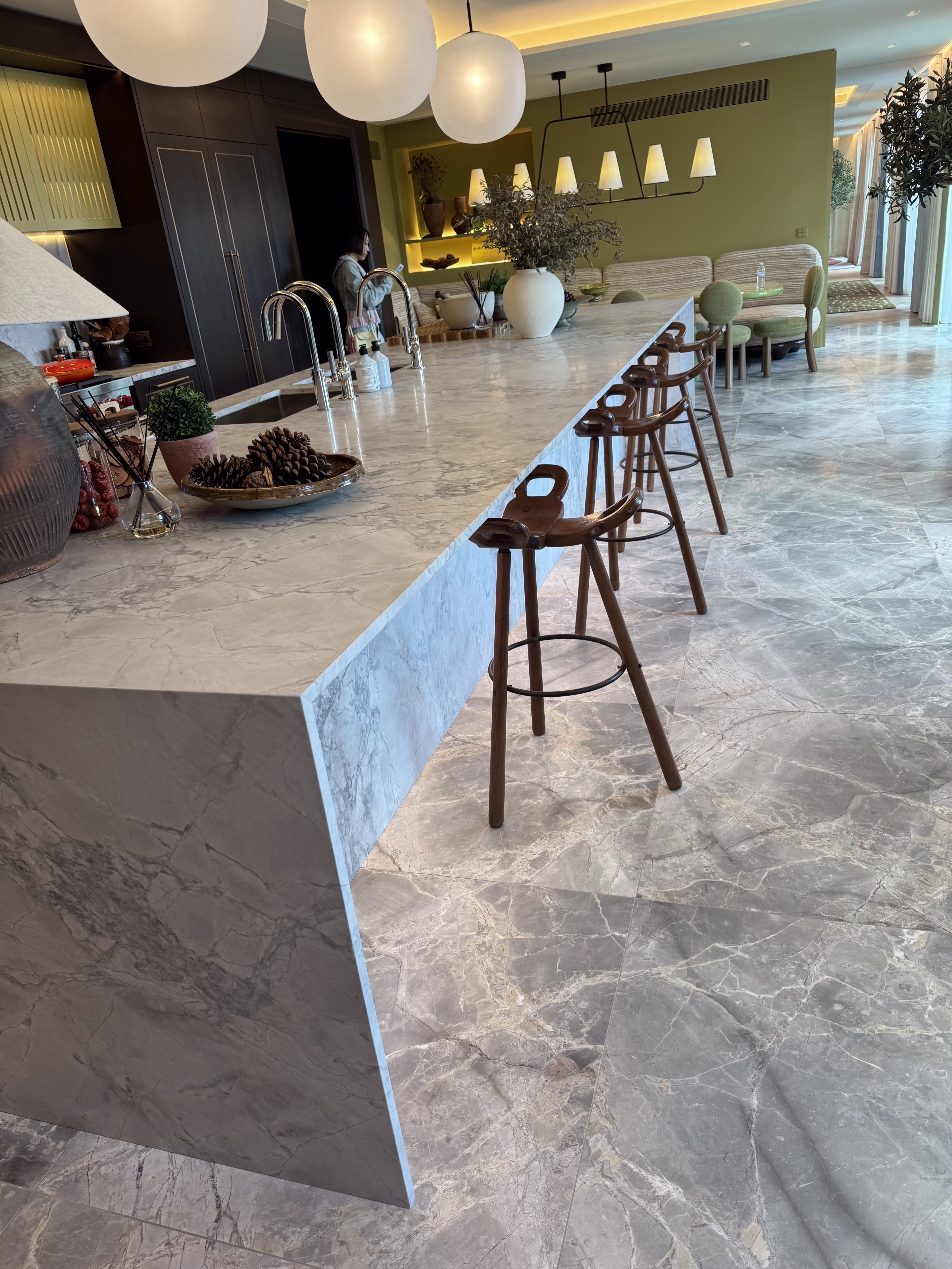 A contemporary kitchen with a substantial stone island